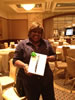 Photo of job coach Monique Thomas winning an iPad at the 14th Employment Supports Symposium